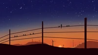 Coucher de soleil serein sur des éoliennes avec des oiseaux sur une clôture