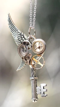 Vintage winged key pendant with intricate steampunk details.