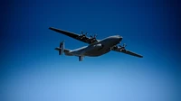 Military Aircraft in Flight Under Clear Blue Sky