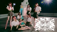 Ive Girl Group in a Theatrical Setting with Stylish Outfits and Dramatic Lighting