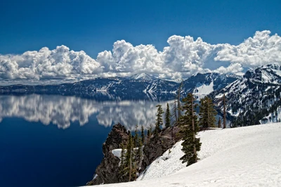 Crater Lake: A Majestic Winter Landscape with Snow-Capped Mountains and Reflective Waters