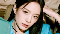 Jang Gyuri of Fromis 9 in a striking portrait, showcasing her captivating gaze and stylish flair.