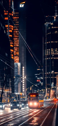 Illuminated Urban Nightscape with Skyscrapers and Tram