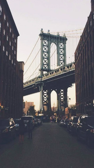 Manhattan Bridge at Dusk Between Brick Buildings