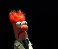 Beaker from The Muppets with a shocked expression, wearing a lab coat and tie.