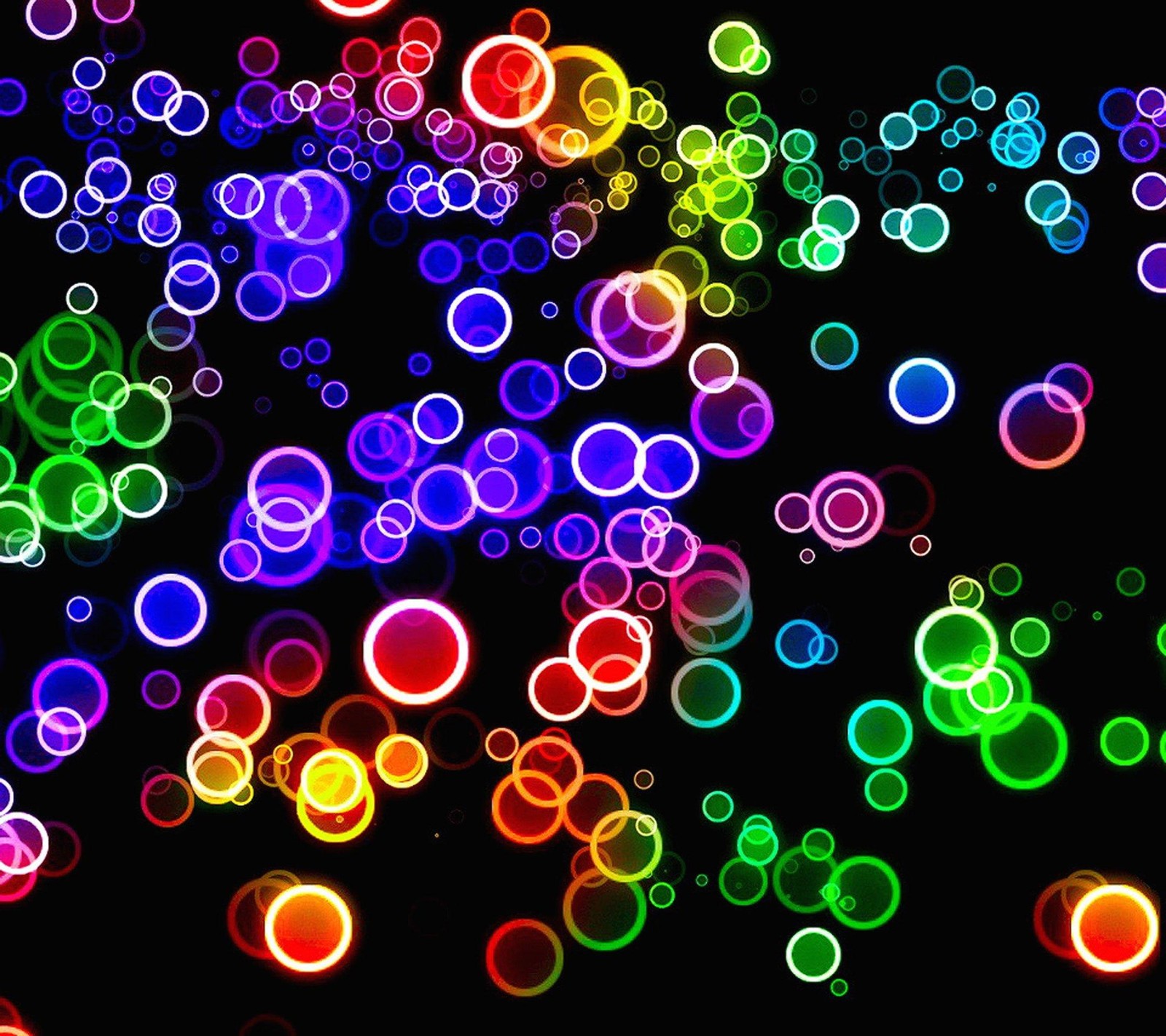 A close up of a bunch of colorful circles on a black background (blue, green)