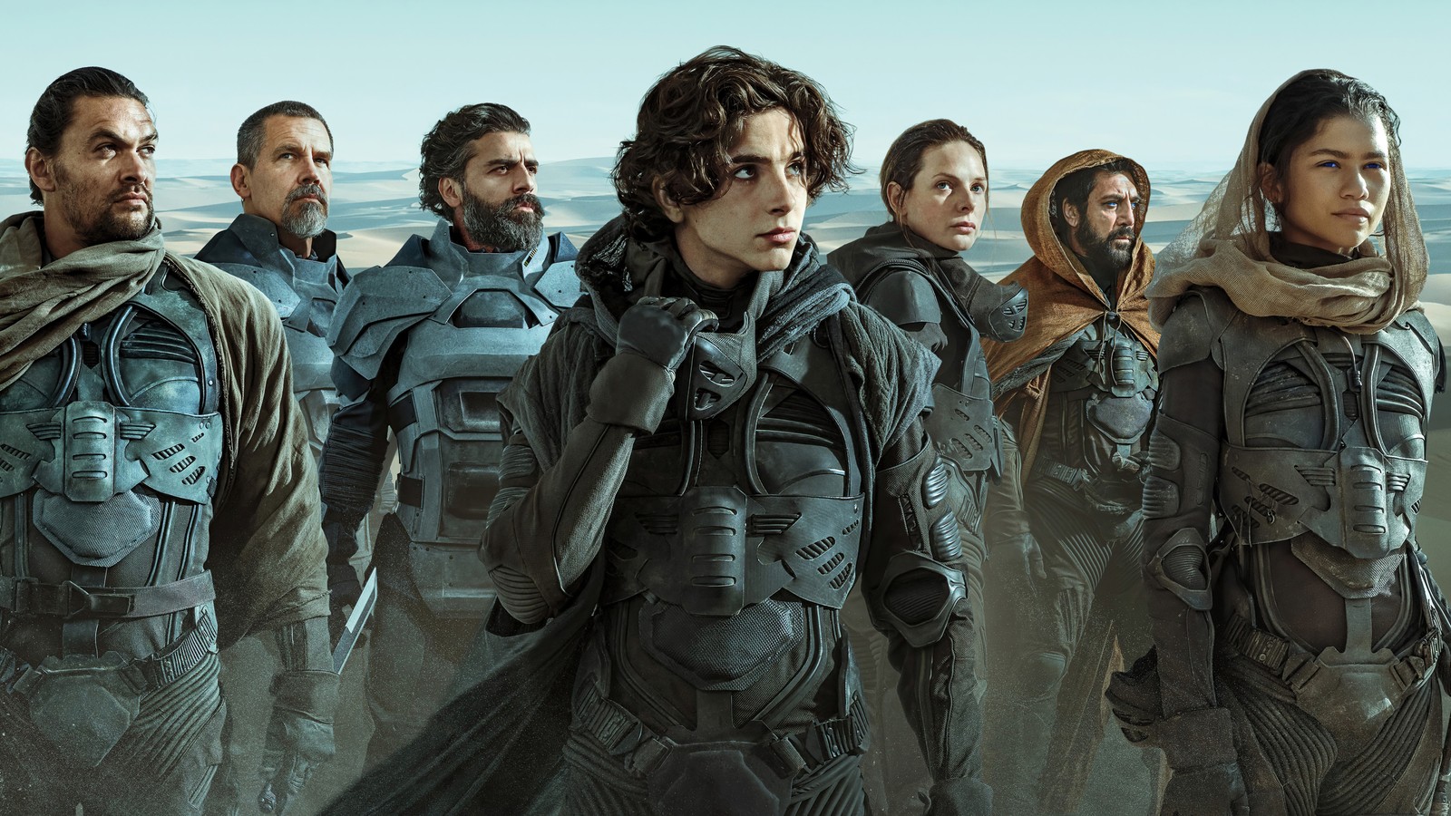 Un groupe de personnes en vêtements futuristes se tenant dans le désert (dune, film, personnages)