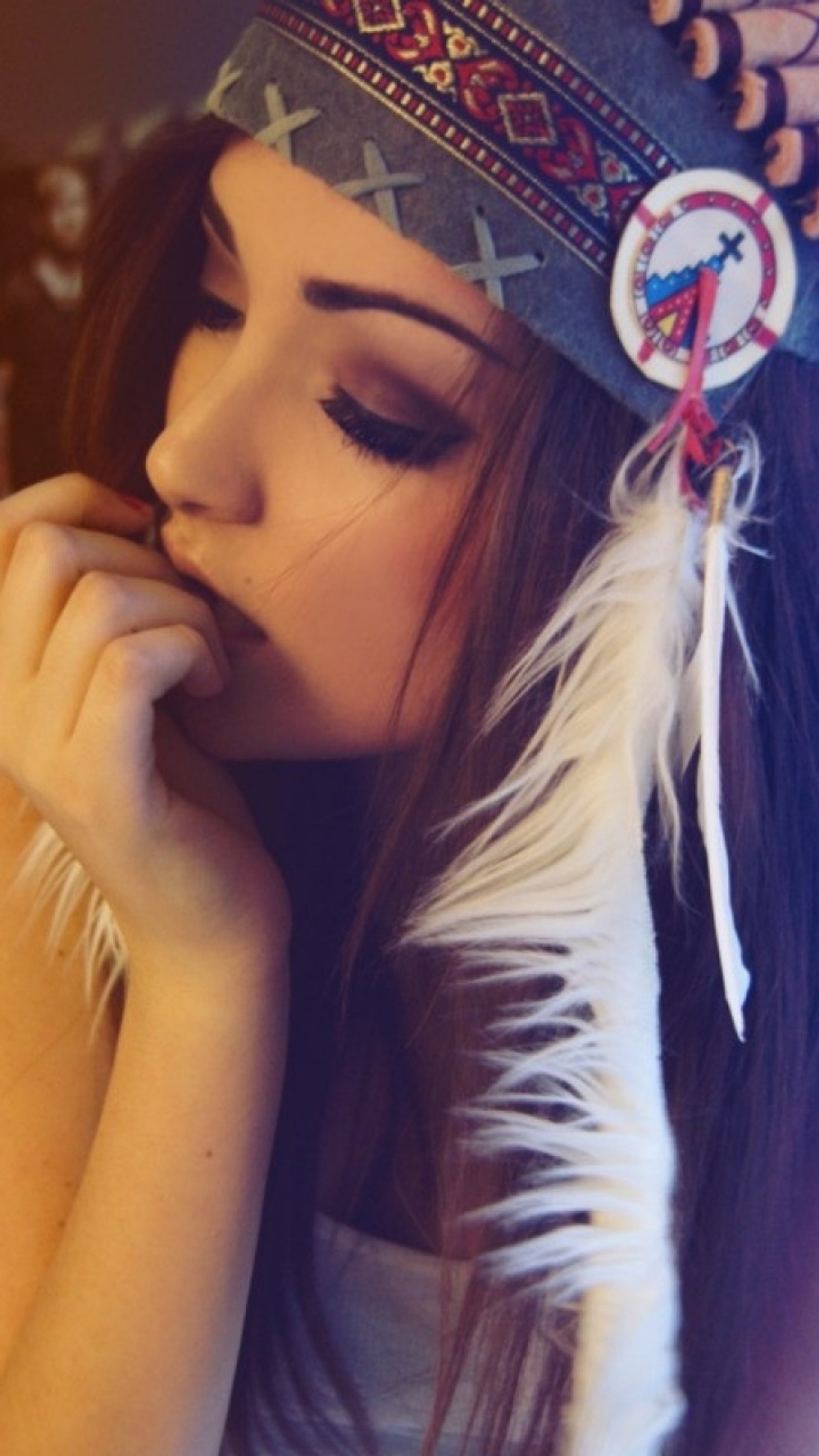 Arafed woman in a native headdress with a feather on her head (girl, love)