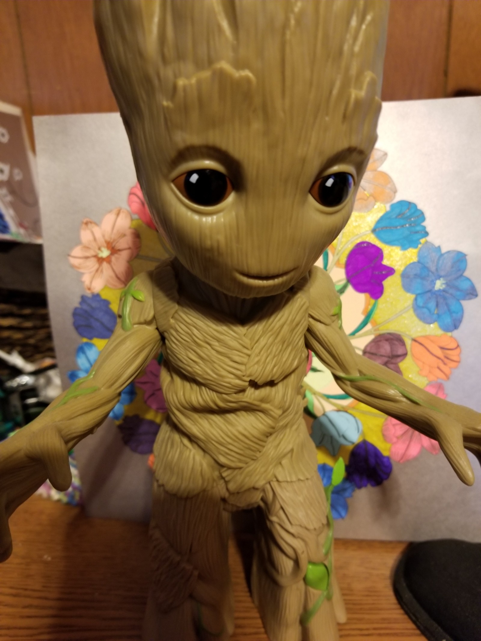 A close up of a toy of a grooter on a table (baby groot, groot)