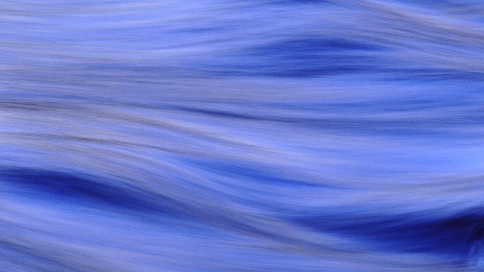 A close up of a blurry photo of a blue river (blue, wave, water, azure, atmosphere)