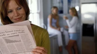 Focused Student Engrossed in Reading News Article