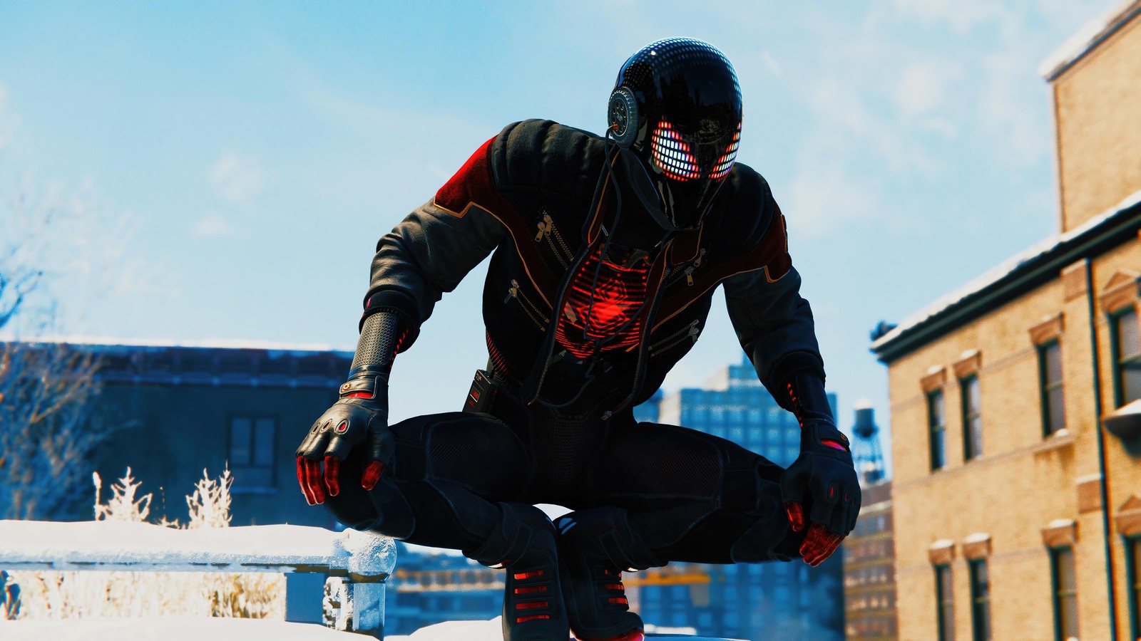 Человек-паук в черном костюме присел на карнизе в снежном городе (marvels spider man miles morales, playstation 5, ps5, ps4, видеоигра)