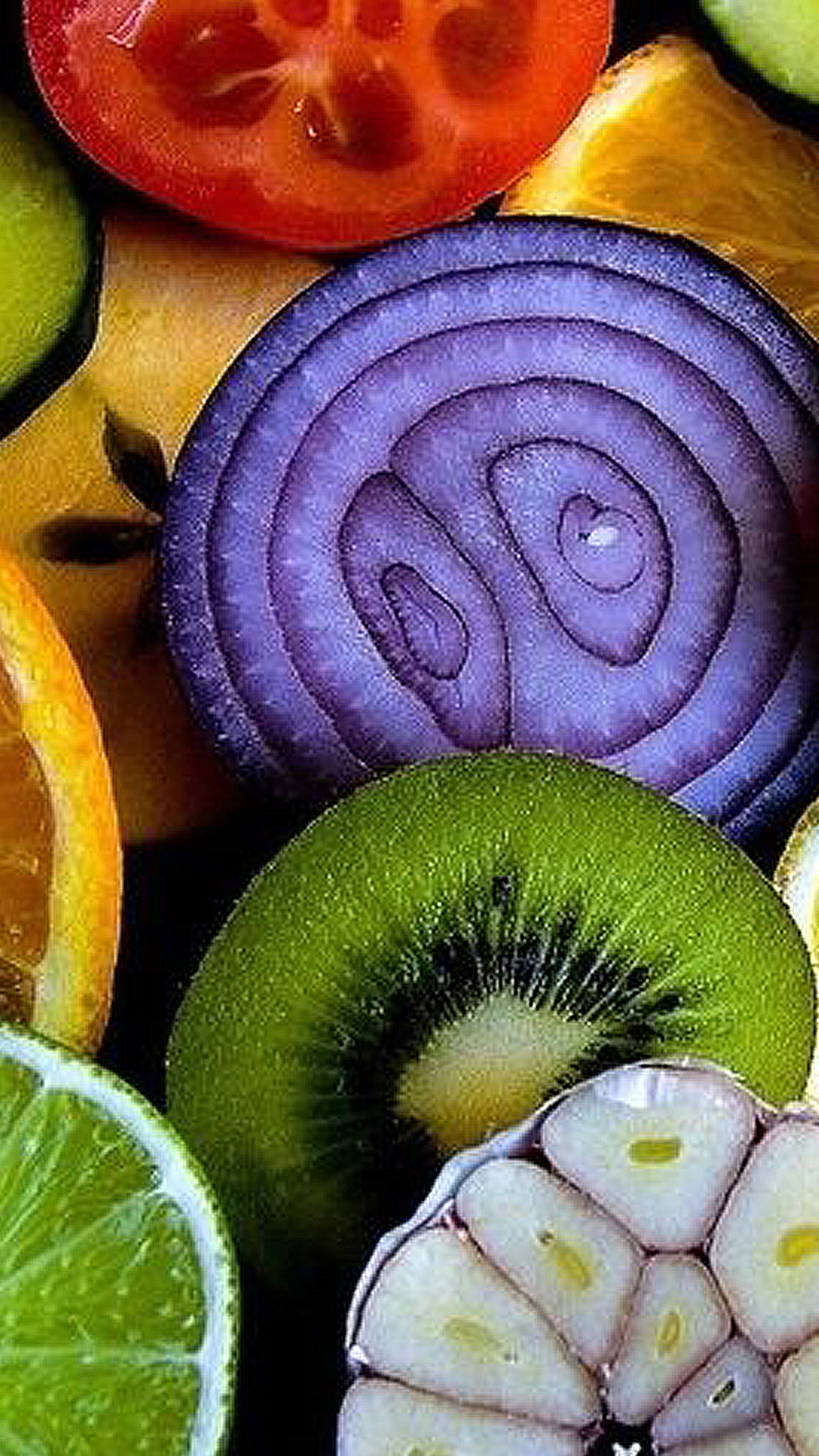 There are many different fruits and vegetables that are cut up (color, food, green, orange, purple)