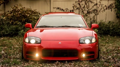 Mitsubishi 3000GT : Voiture de sport JDM rouge classique dans un cadre automnal