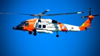 U.S. Coast Guard Helicopter in Flight Against a Clear Sky