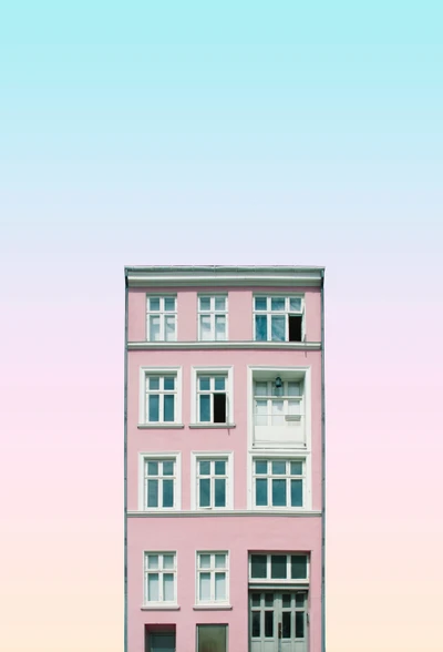 Fachada de apartamento rosa con líneas arquitectónicas contra un cielo de degradado suave