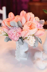 Elegant pink floral bouquet featuring peonies, roses, and delicate greenery, perfect for weddings and special events.