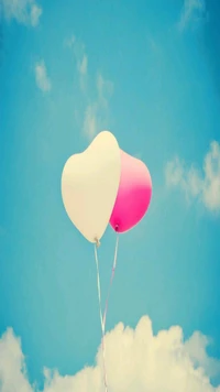 Heart-Shaped Balloons in a Blue Sky