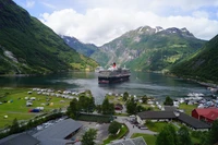 Geirangerfjord: A Scenic Cruise Amidst Majestic Mountains and Lush Highland Landscapes.