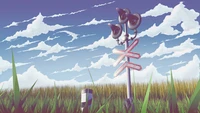 Tranquil Grassland with Railway Signal Under a Cloudy Sky