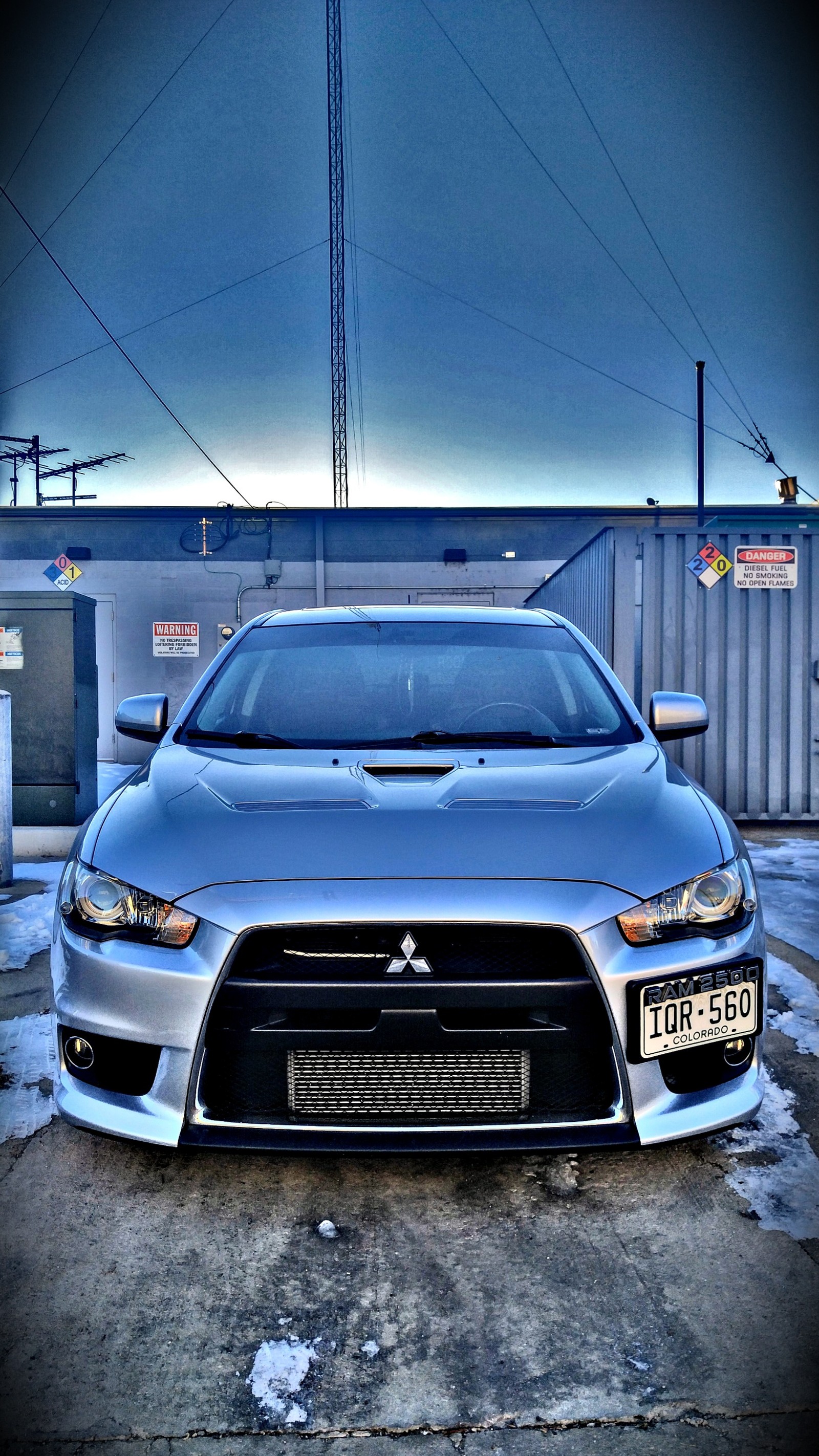 Arafed car parked in a parking lot with a lot of snow (cars, evo, evo x, evolution, lancer)