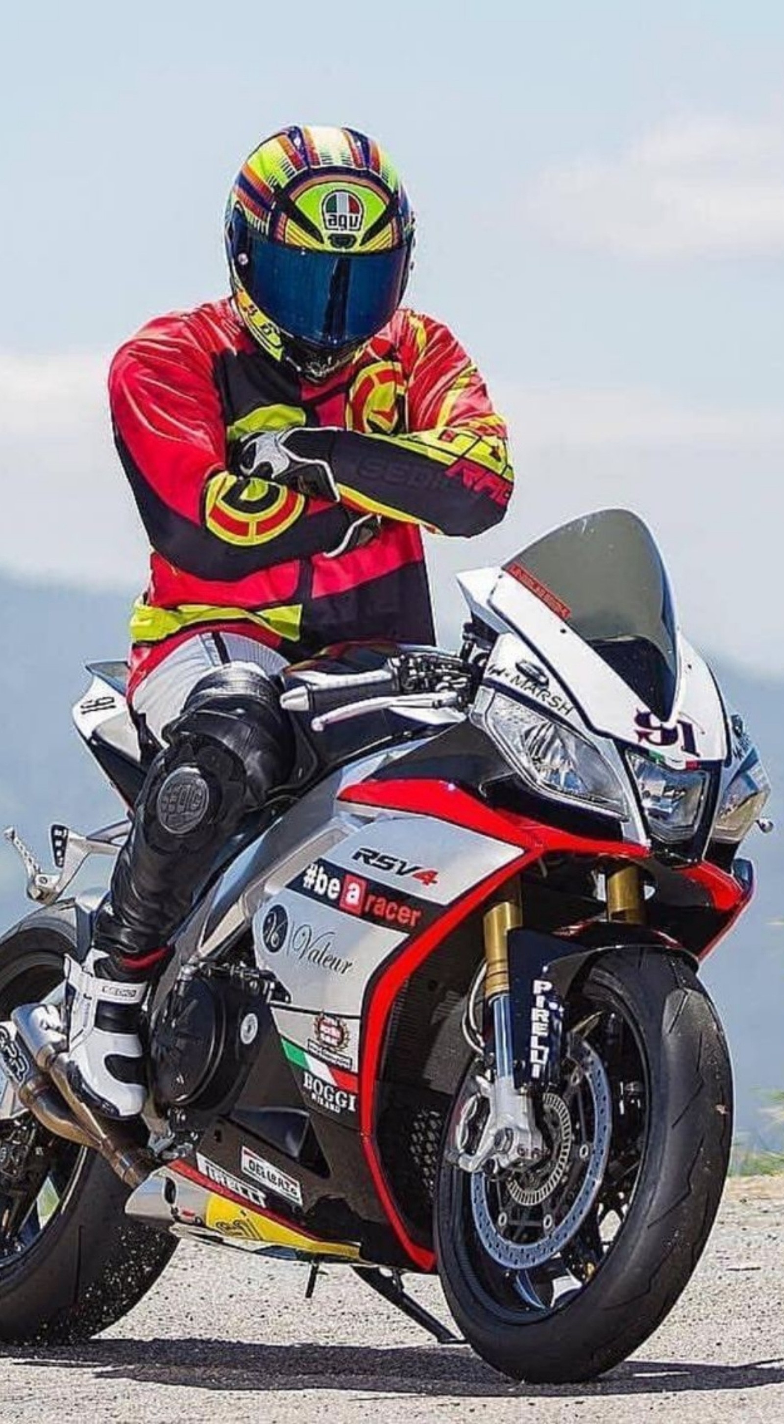 Arafed man in a red and black jacket and helmet on a motorcycle (bike, motor, motorcycle, motors)