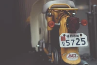 Vintage Honda Scooter with Distinctive Yellow Design and License Plate