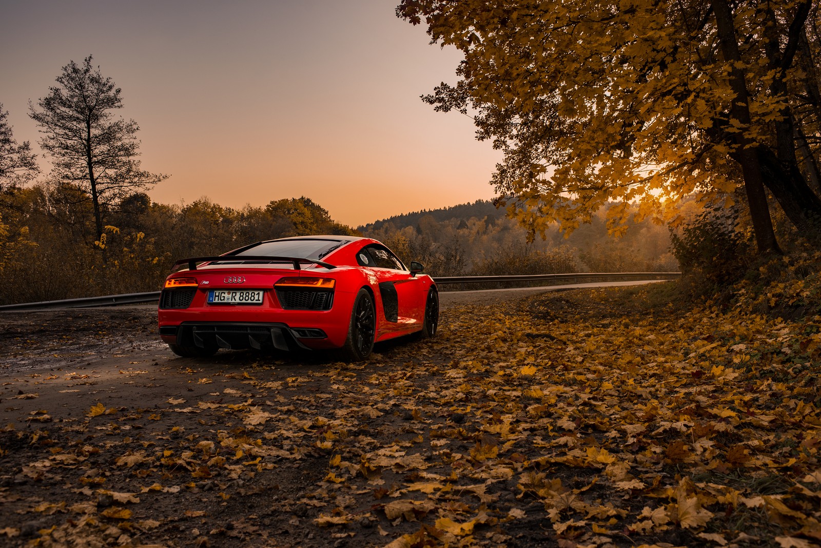 A red sports car parked on a road in the fall (song, sports car, video, music, supercar)