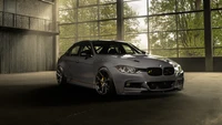 Sleek BMW 3 Series in a modern industrial setting with dramatic lighting.