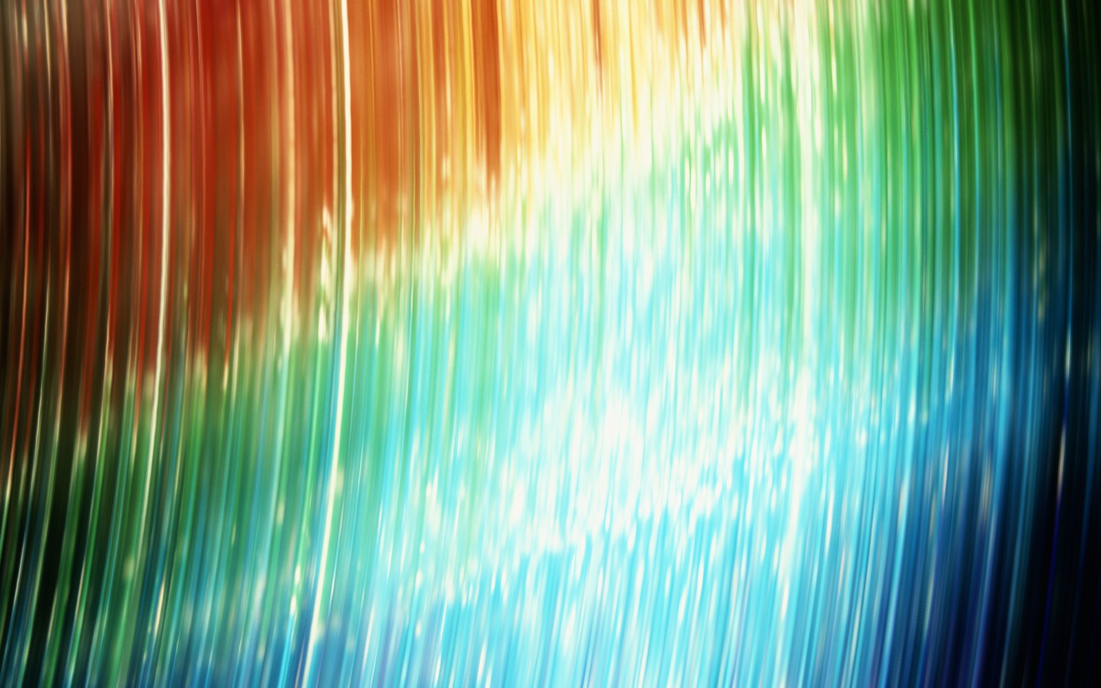 A close up of a colorful background with a blurry image of a wave (light, green, blue, grasses, sky)