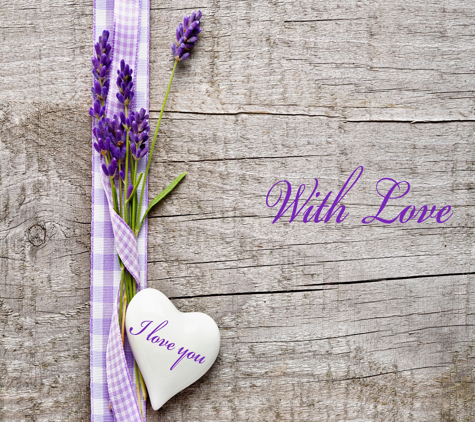 Lavender flowers and a heart shaped ceramic on a wooden table (love, with)