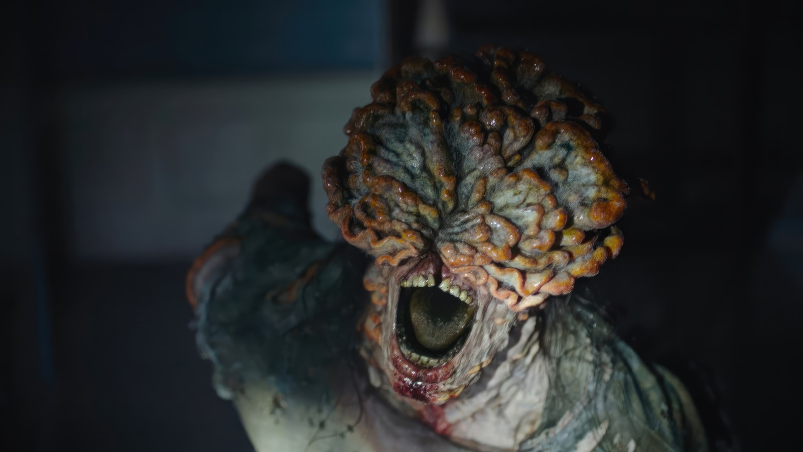 There is a creepy looking creature with a large head and a big mouth (clicker, the last of us series, tv series, hbo max, the last of us)