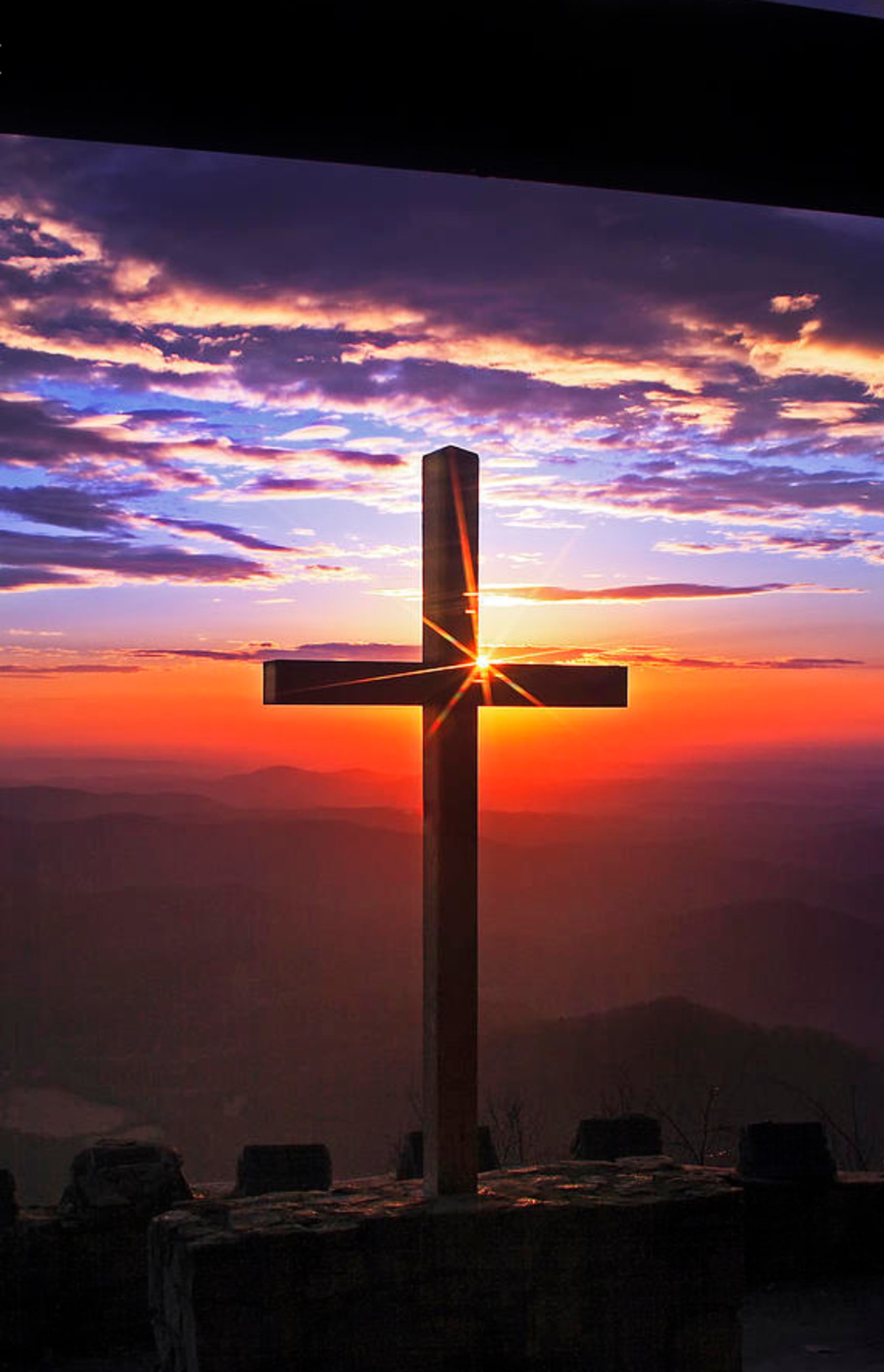 Arafed cross on a mountain with a sunset in the background (christian, cross, jesus, sky)