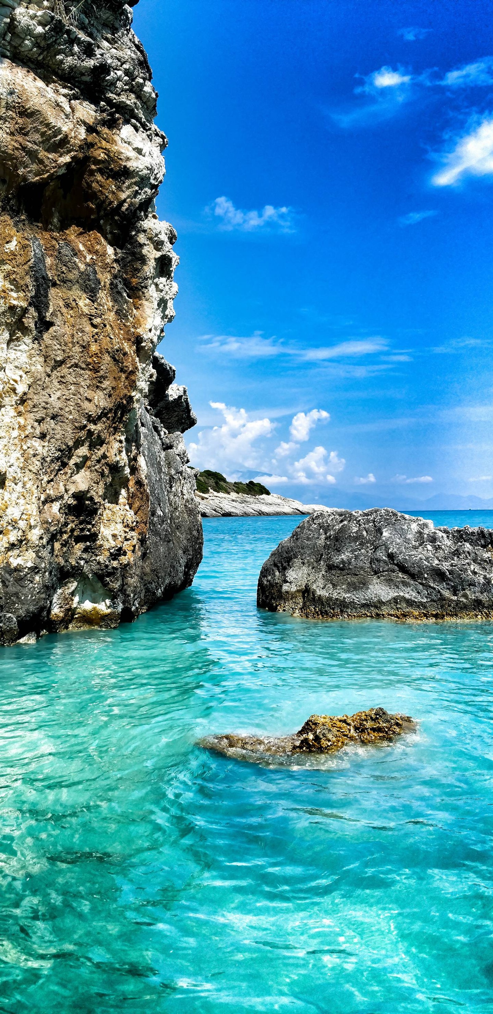 There is a large rock in the water near a large rock (my, pops)