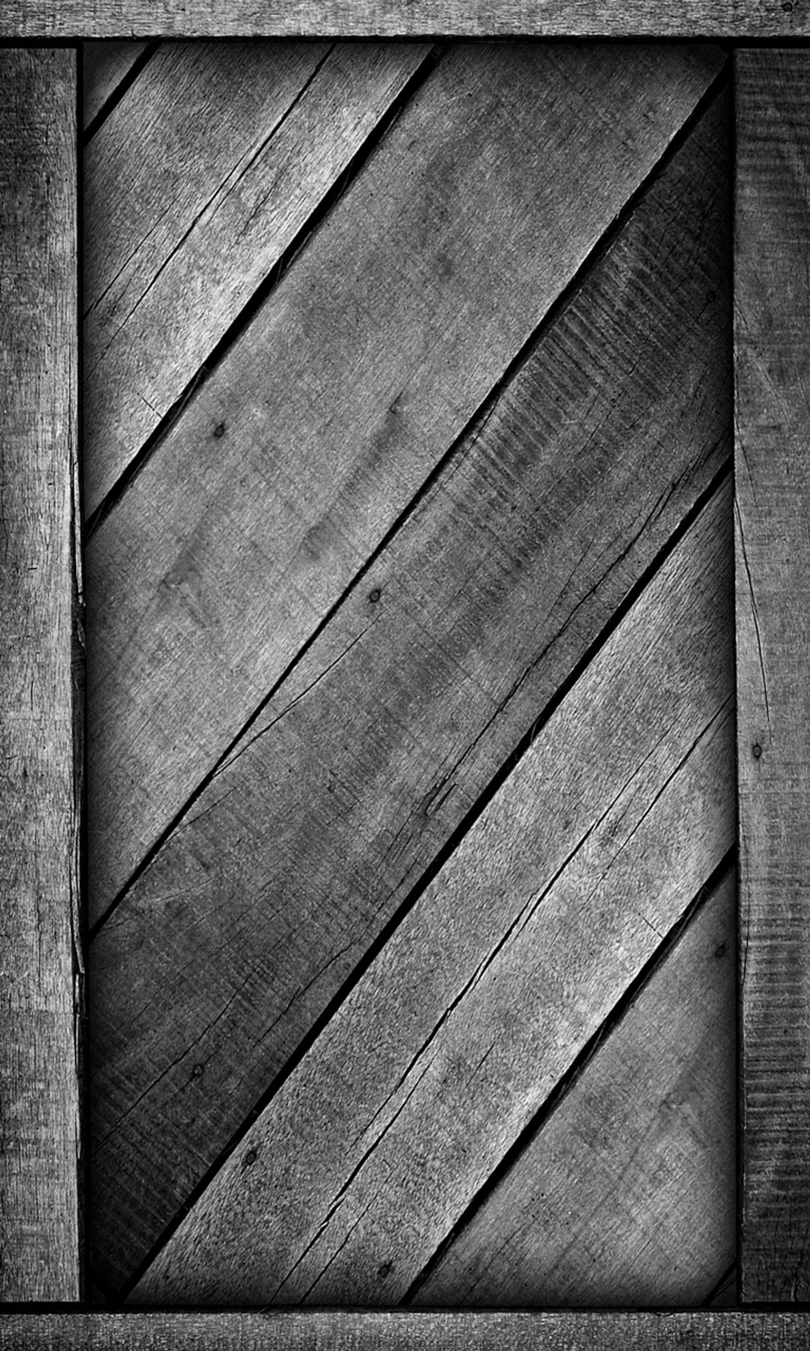 A black and white photo of a wooden frame with a diagonal pattern (abstract, wood)