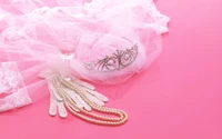 Elegant Wedding Accessories: Pearl Necklace, Gloves, and Tiara on Pink Background