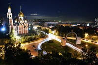 Illuminated Cityscape at Night Featuring a Landmark Church