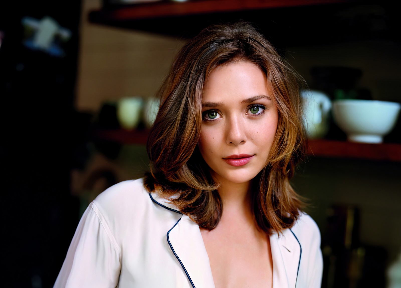 Arafed woman in white shirt posing in kitchen with dishes on shelves (elizabeth olsen, 5k, american actress, beautiful actress, people)