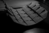 Monochrome Origami Tire Sculpture on a Dark Surface