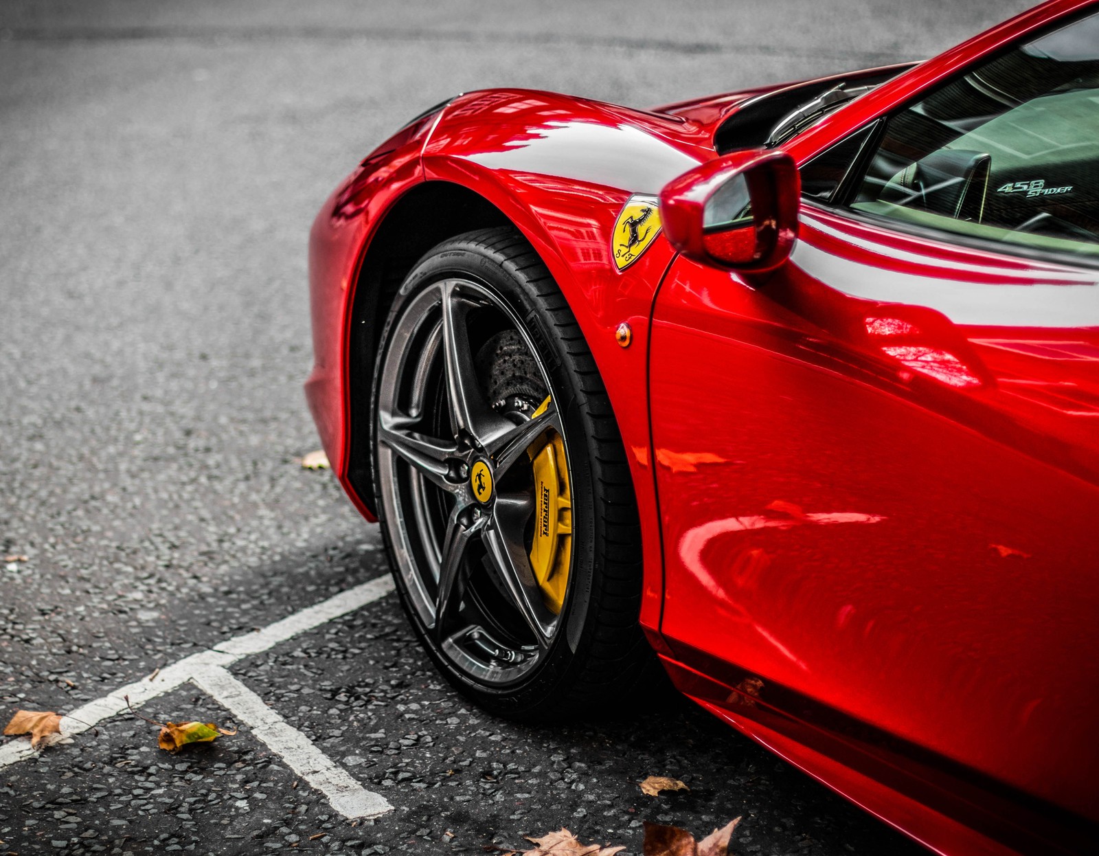 A close up of a red sports car parked in a parking lot (ferrari, gara, italia, italiana, macchine italianea)