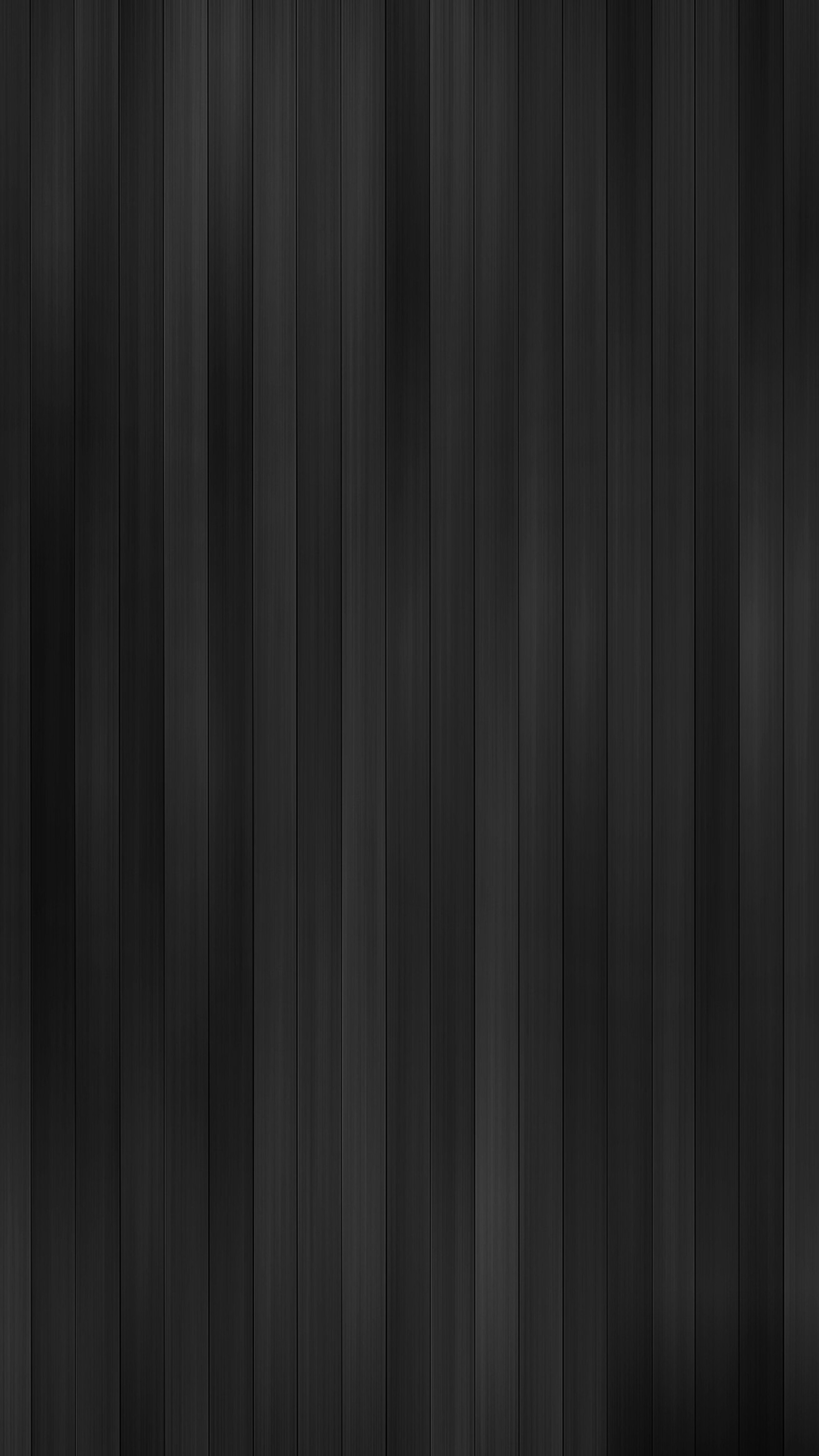 A close up of a black wood paneled wall with a white fire hydrant (gray, wallpaper)