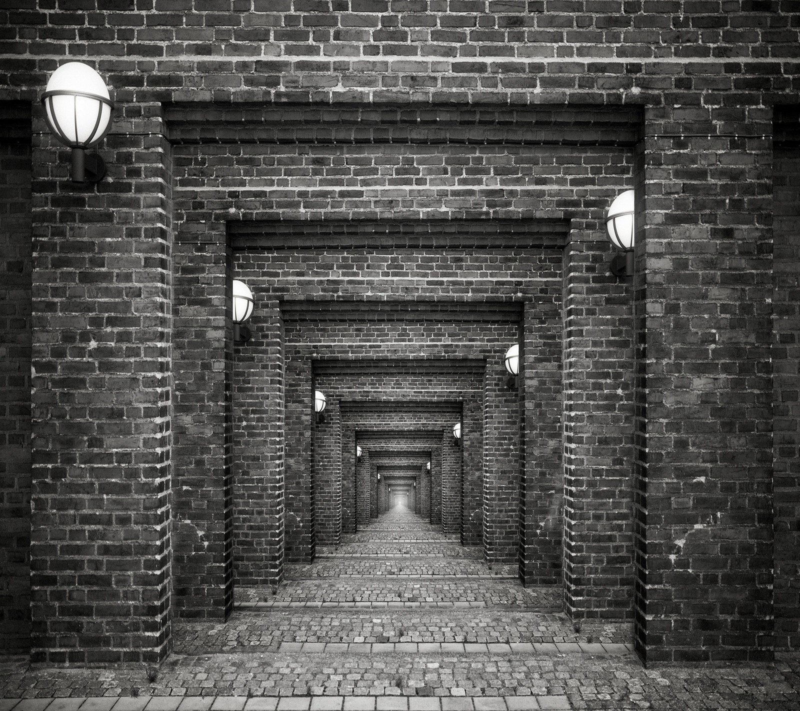 A black and white photo of a brick walkway with lights (abej, beograd, bricks)