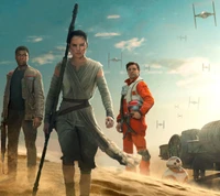 Rey, Finn, and Poe in a desert landscape with TIE fighters overhead in "The Force Awakens.