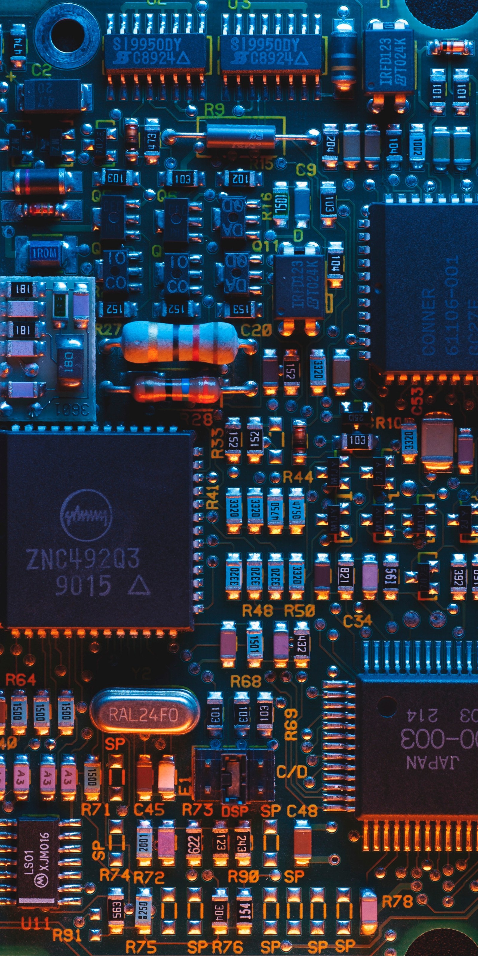 A close up of a computer mother board with many electronic components (electronics, printed circuit board, electronic circuit, apples, circuit component)