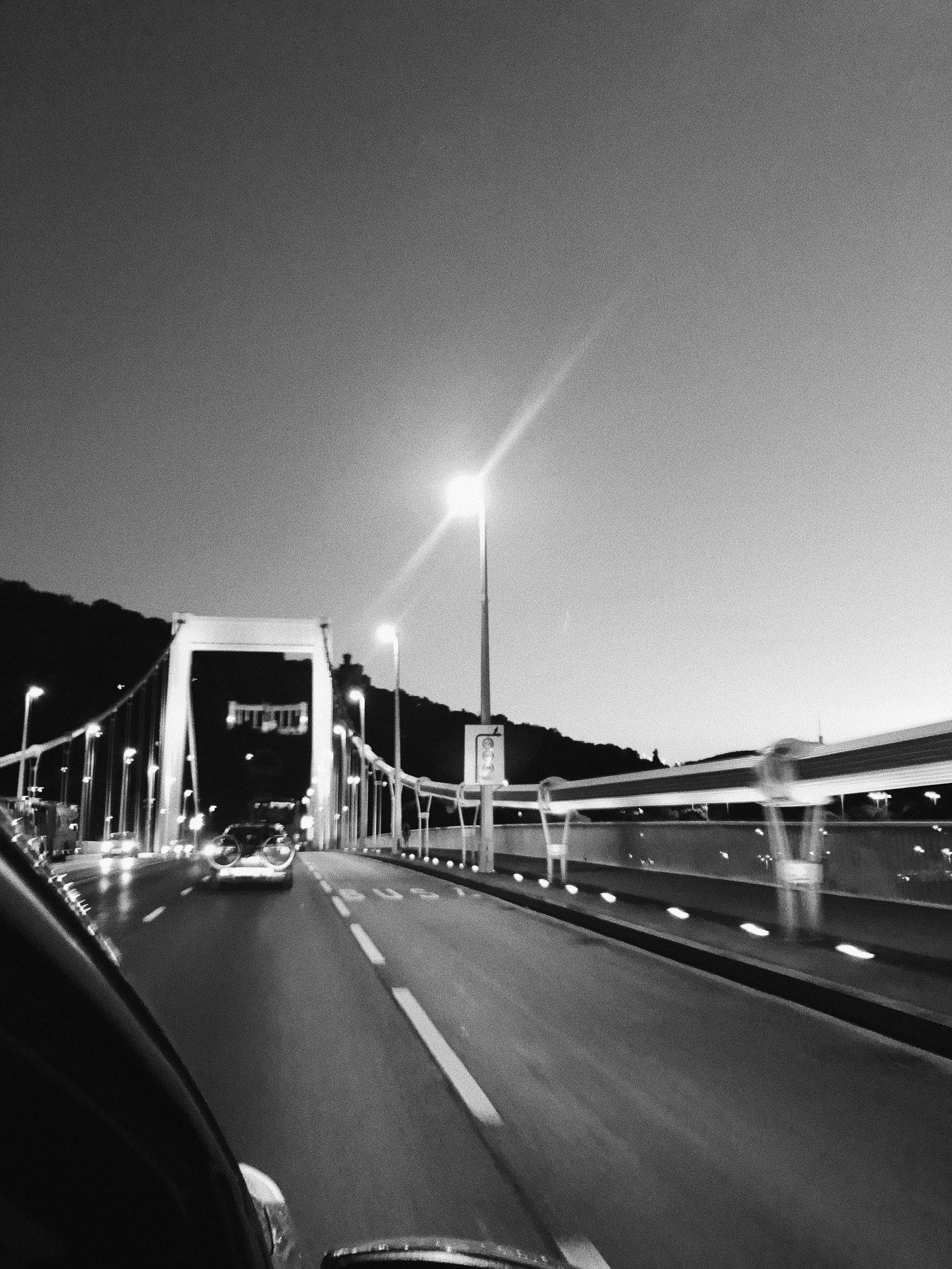 Arafed view of a bridge with cars driving on it at night (king, road, road surface, infrastructure, automotive lighting)