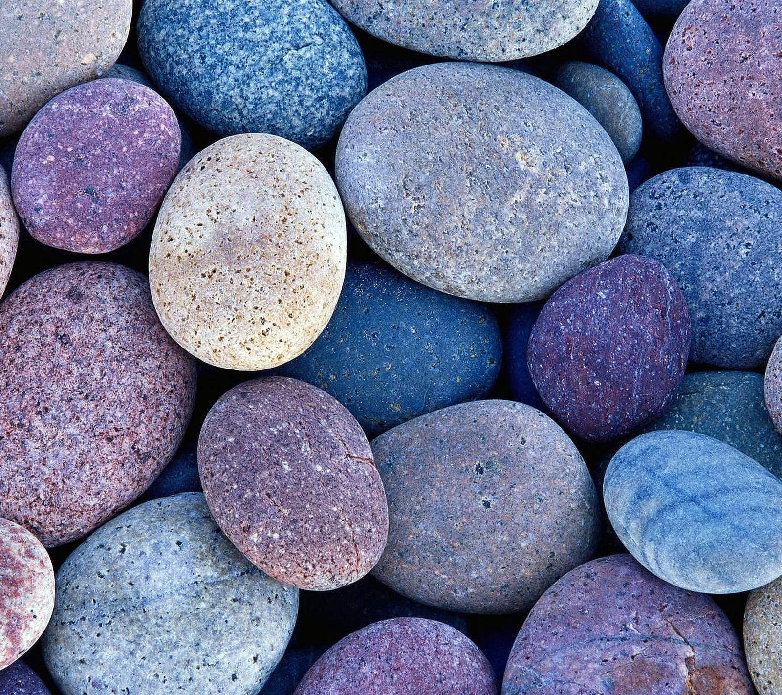 A close up of a pile of rocks with a blue and purple one (2160x1920, wallpaper)