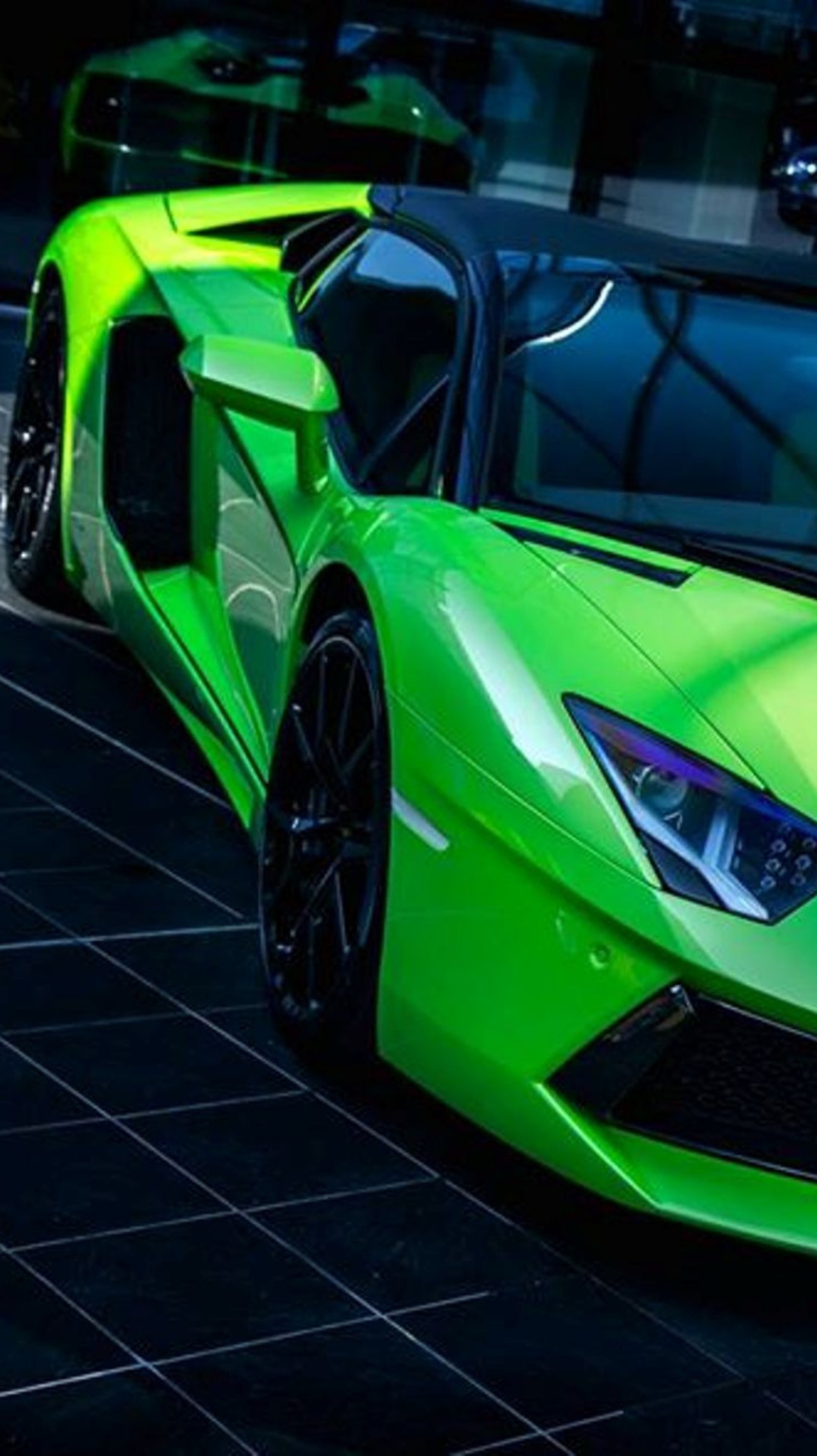 A close up of a green sports car parked on a street (car, green, lamborghini, tuned)