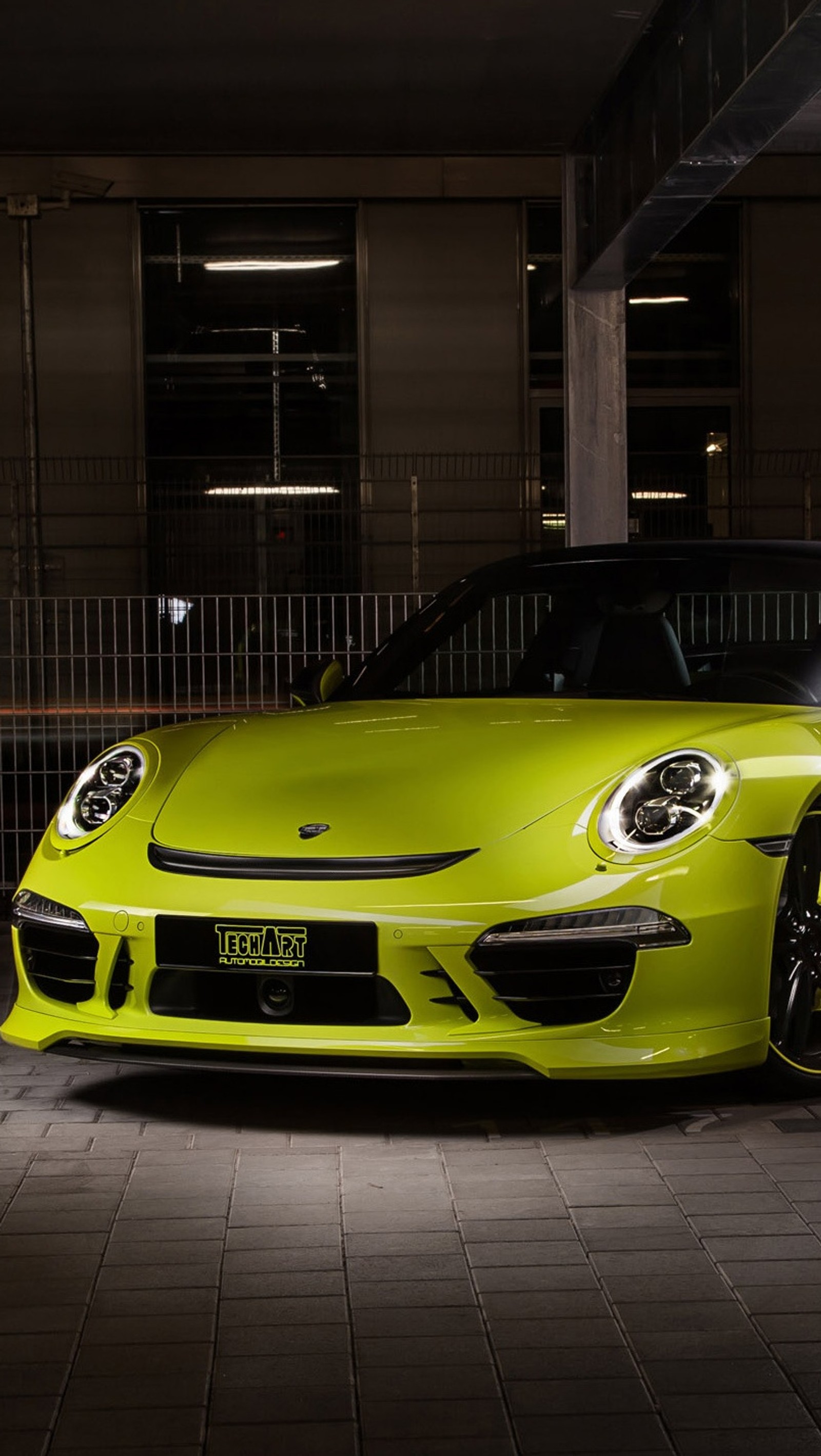 A close up of a yellow sports car parked in a parking garage (car, green, hd, porsche)