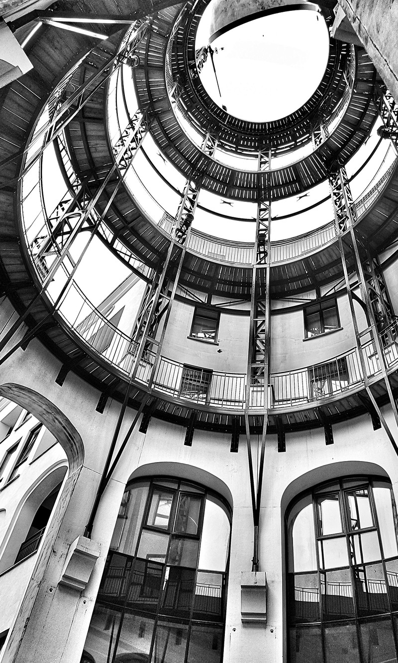 Arafed view of a building with a circular staircase and a clock (black, love)