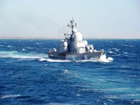 Guided Missile Destroyer Navigating Through Turbulent Waters